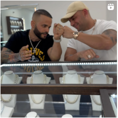 Two men are looking at necklaces in a store