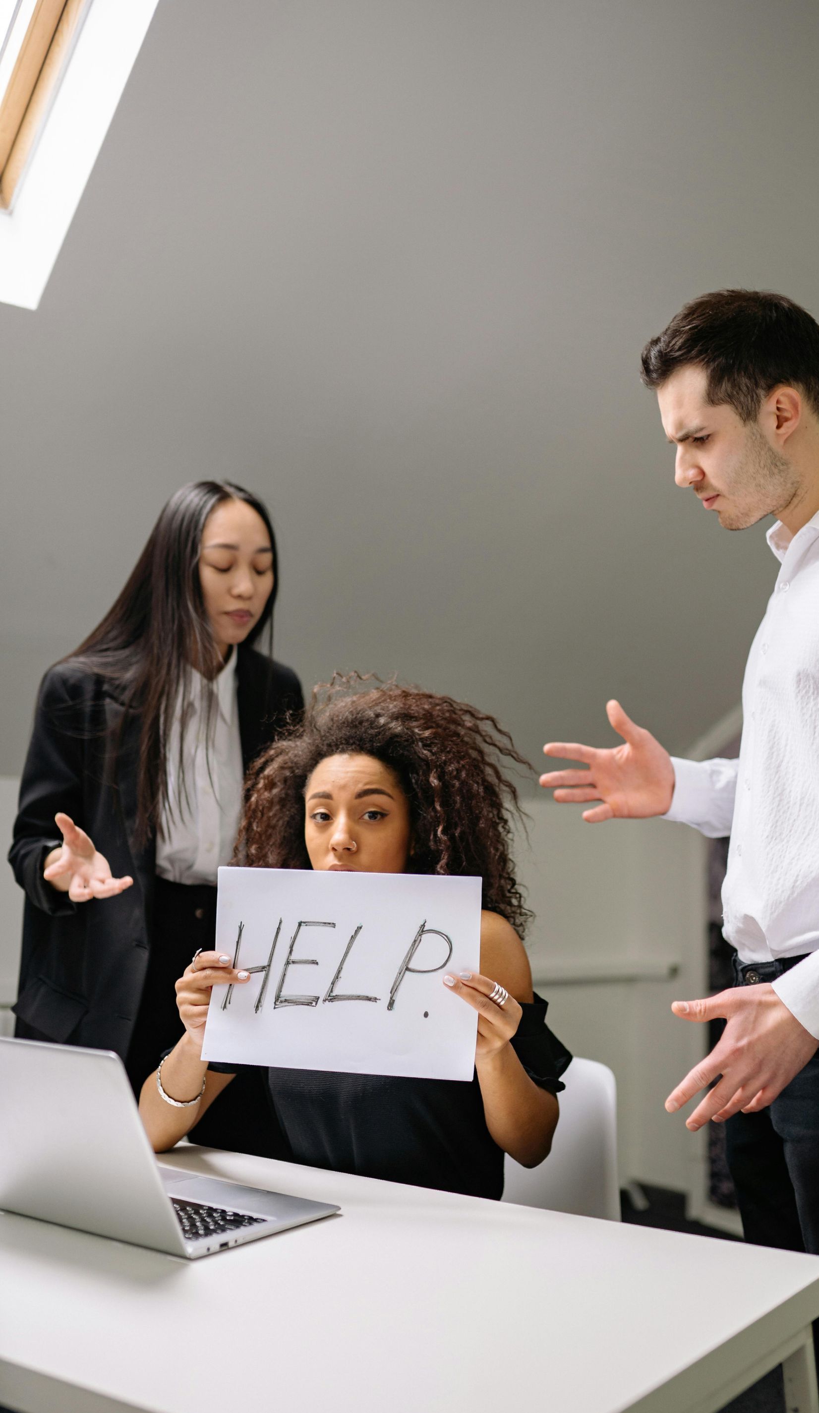 Three office workers in conflict; one holds