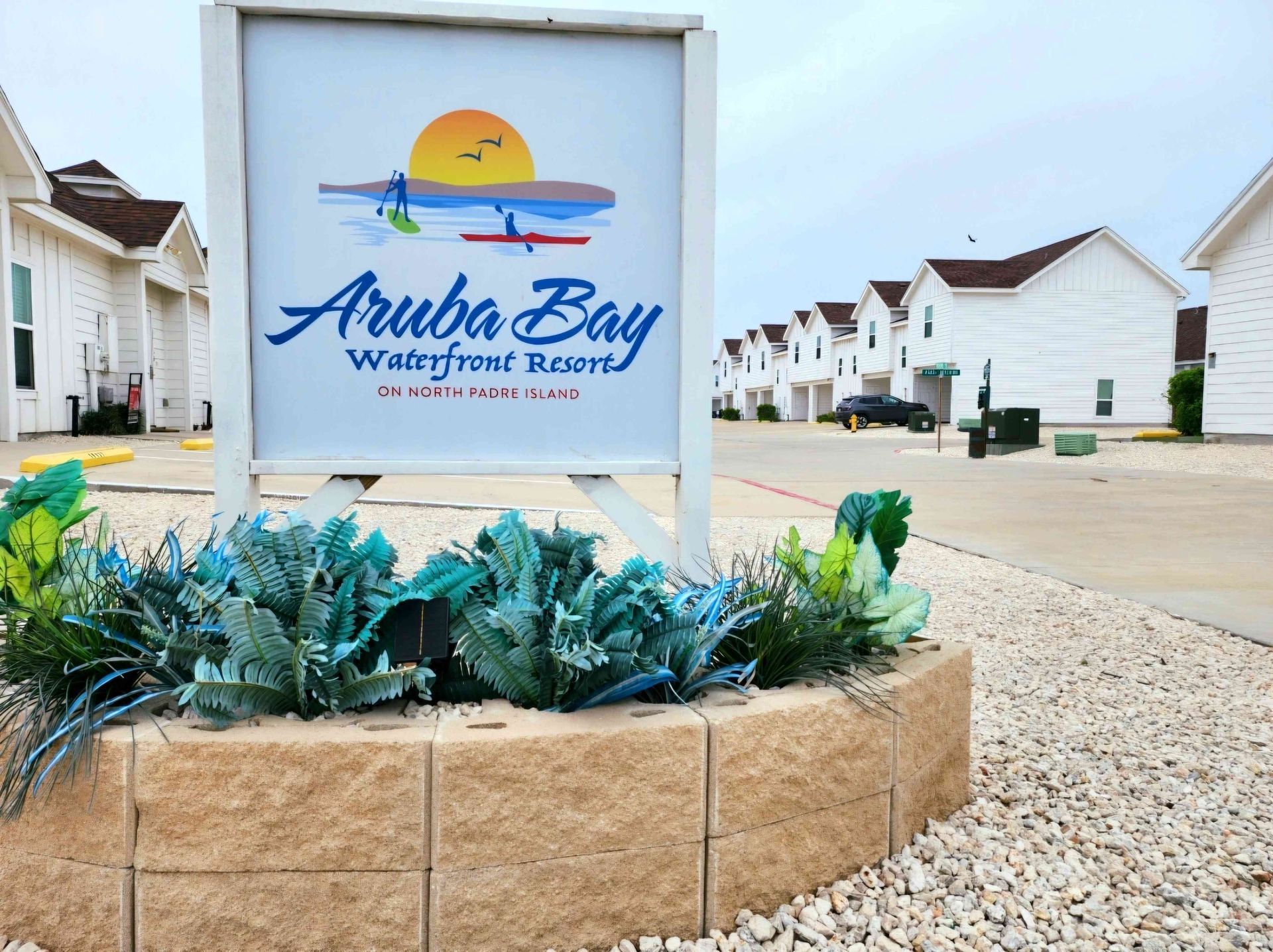 A sign for the aruba bay waterfront resort
