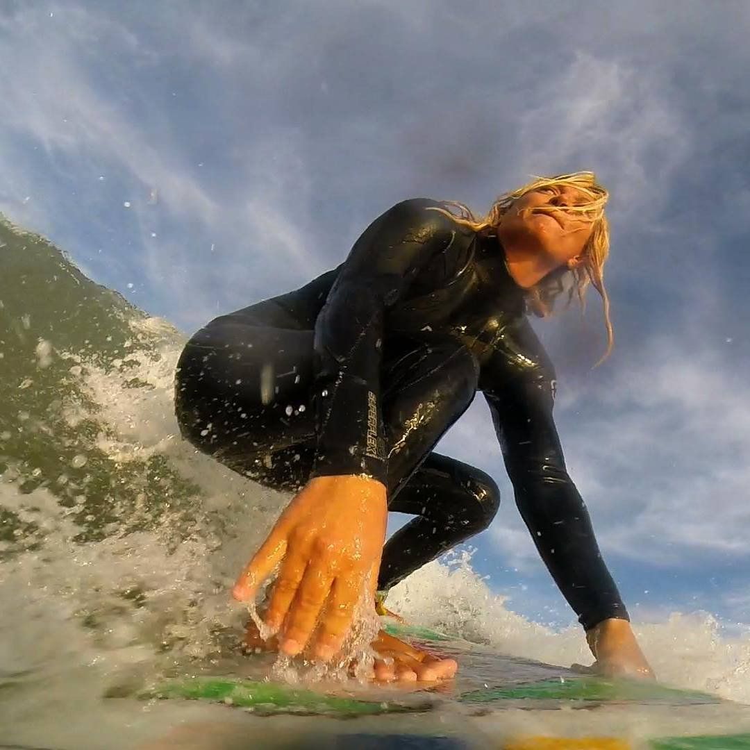 Angelica Clemmer surfs the ocean