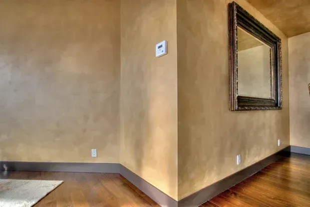 There is a large mirror on the wall in the corner of the room.