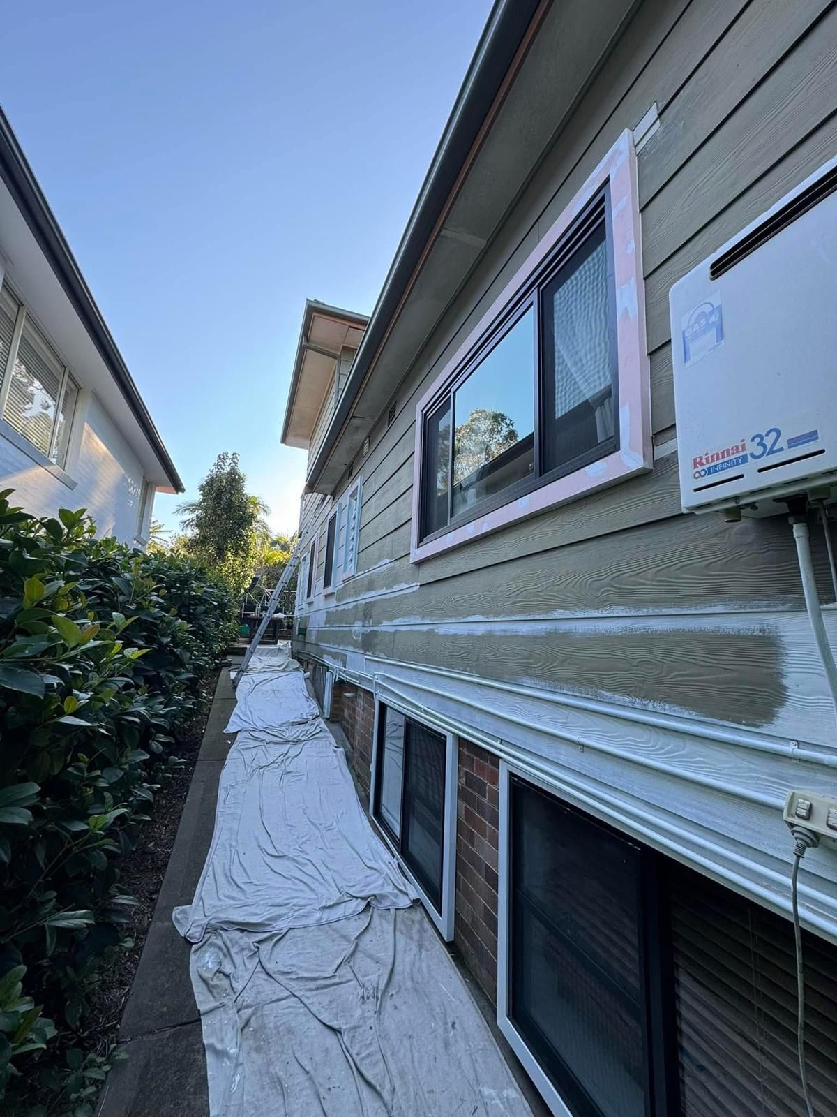 A house is being painted on the side of it.