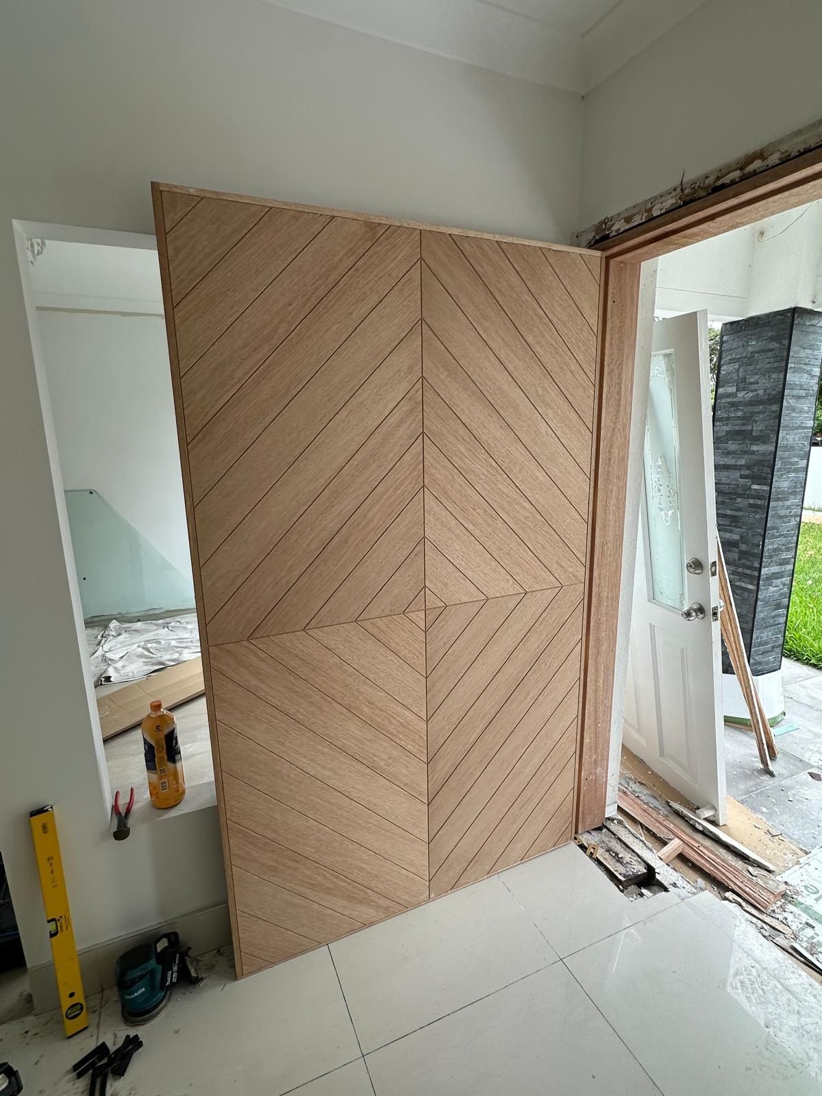 A wooden door is being built in a room.