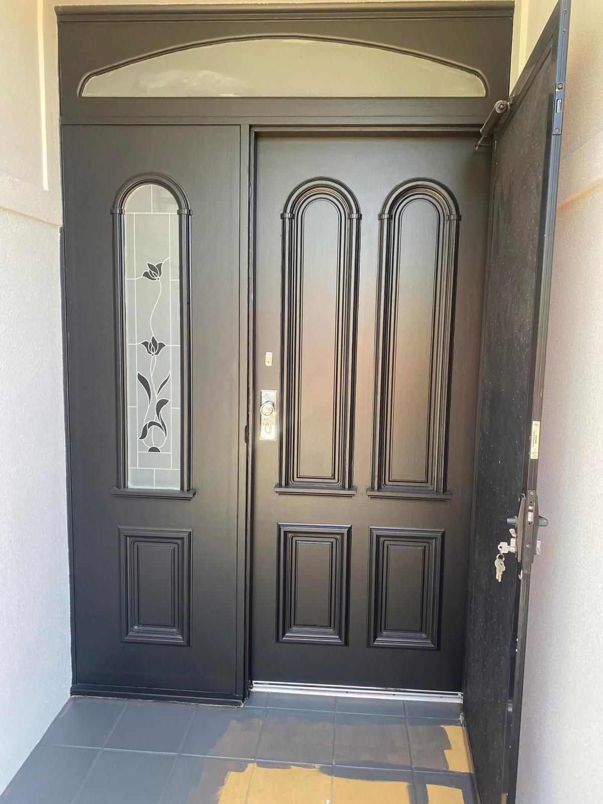 A black door with a floral design on it