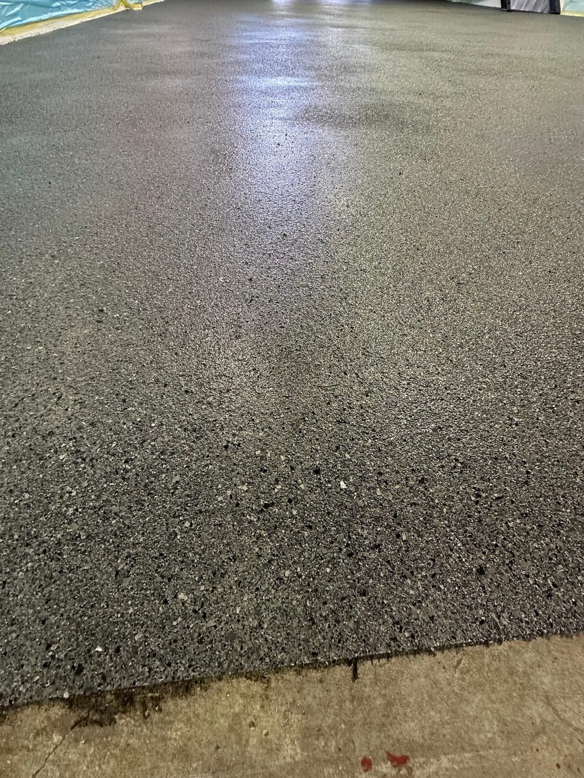 A close up of a concrete floor next to a pool.