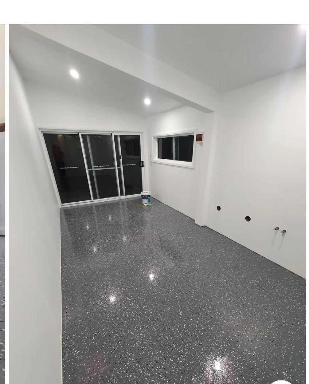 A room with a gray floor and white walls