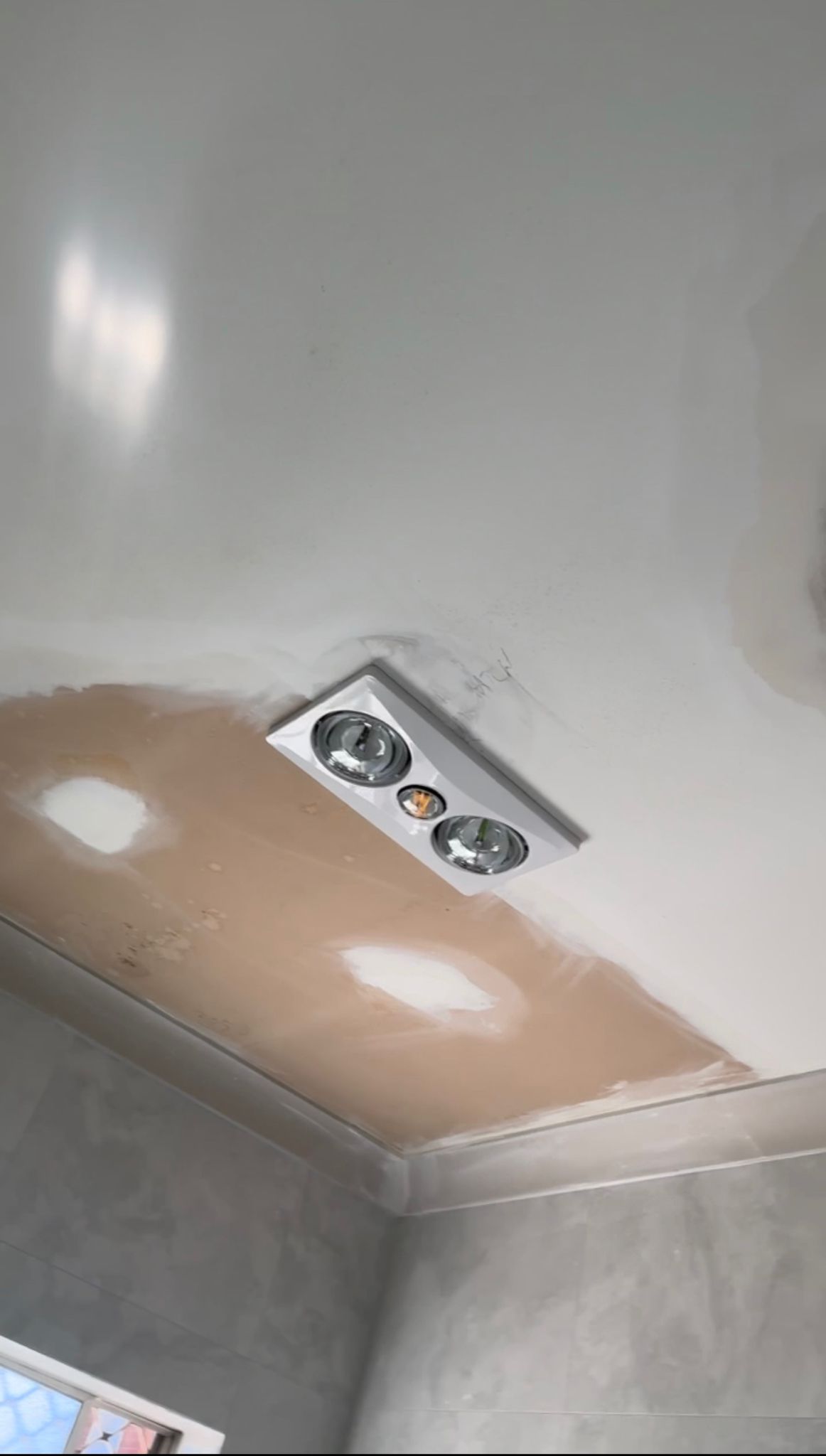 A ceiling fan is being installed in a room.