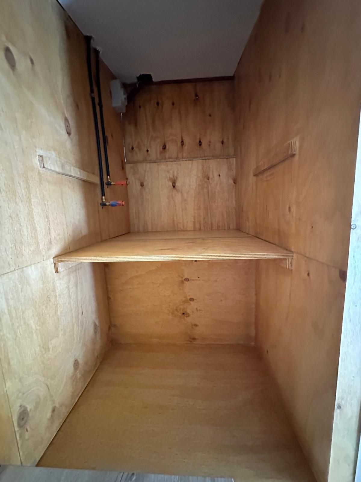 There is a shelf in the middle of the room.