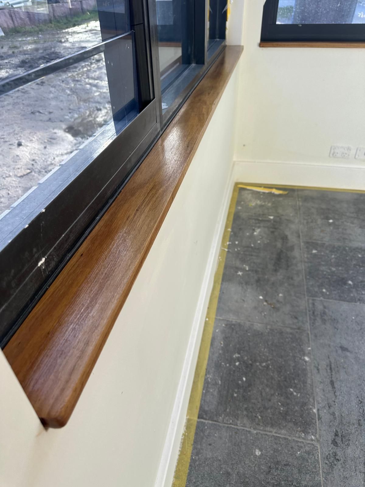 A room with a window and a wooden sill.