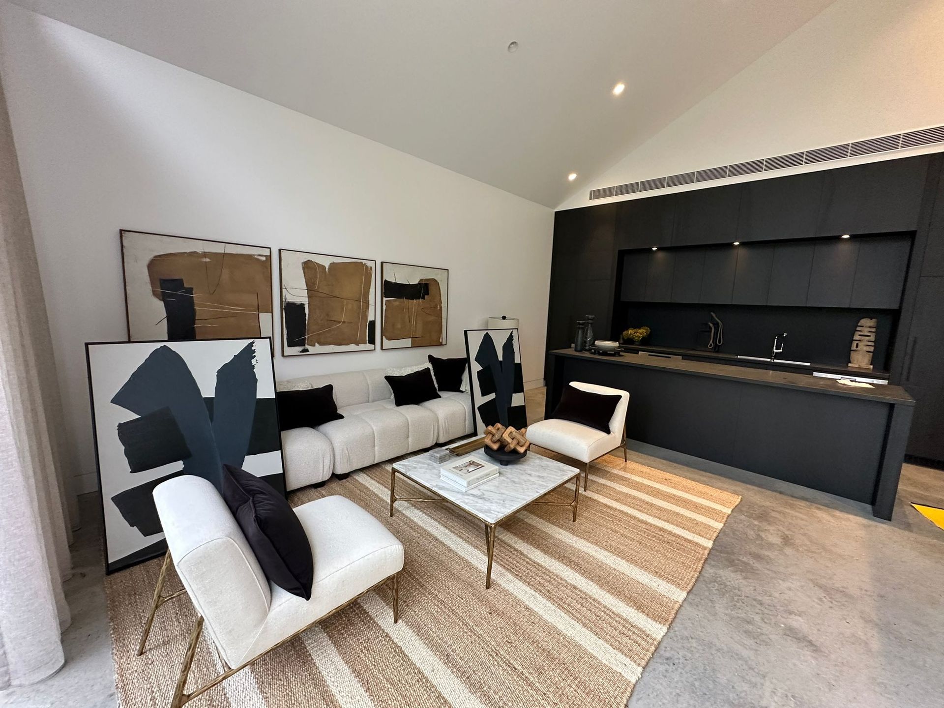 A living room with a couch , chairs , and a coffee table.