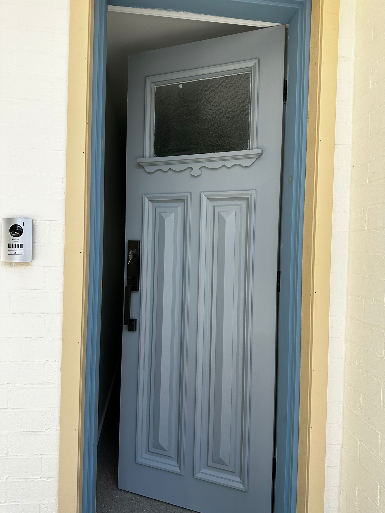 A white door with a blue trim is open