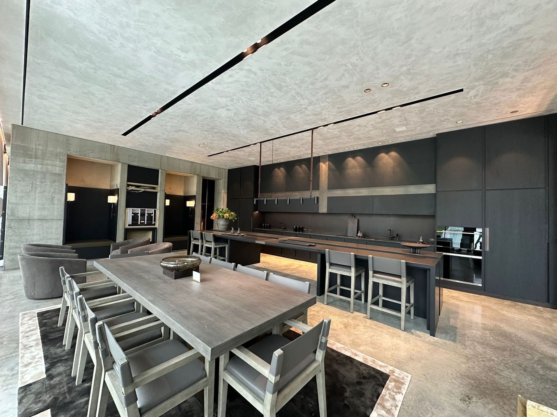 There is a large dining table in the middle of the room.