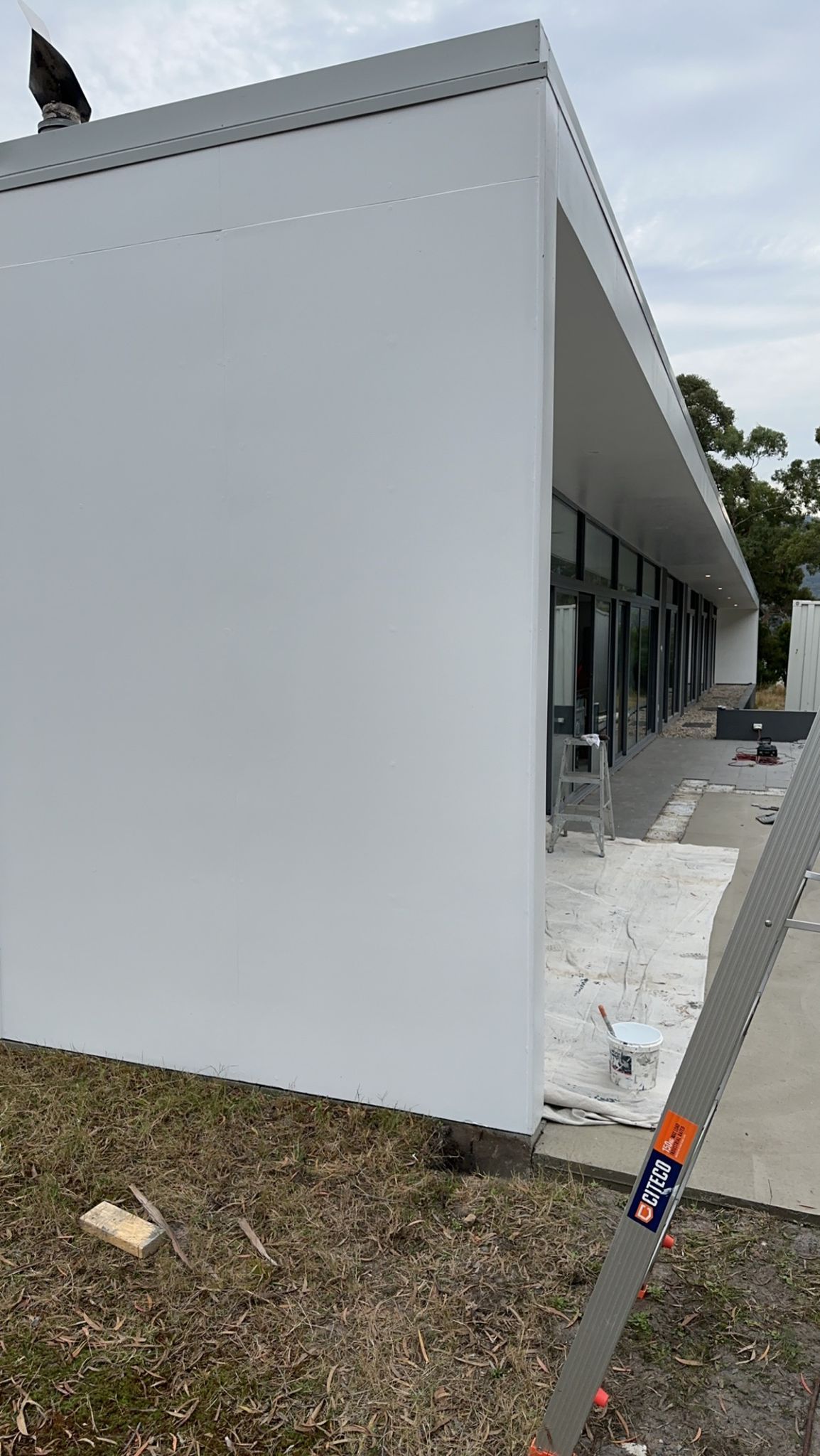 A white building with a lot of windows is being built.
