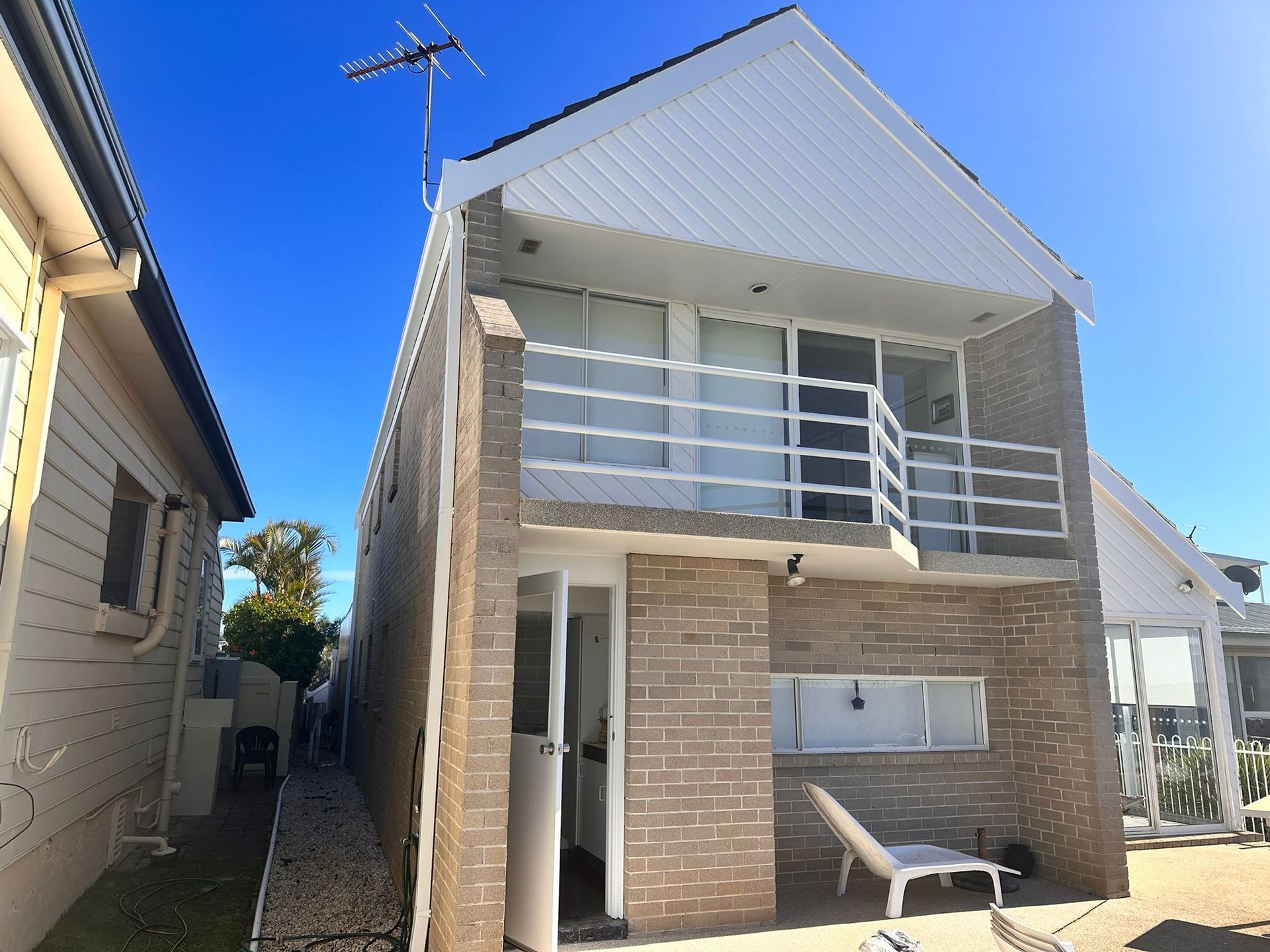 A house with a balcony and an antenna on top of it