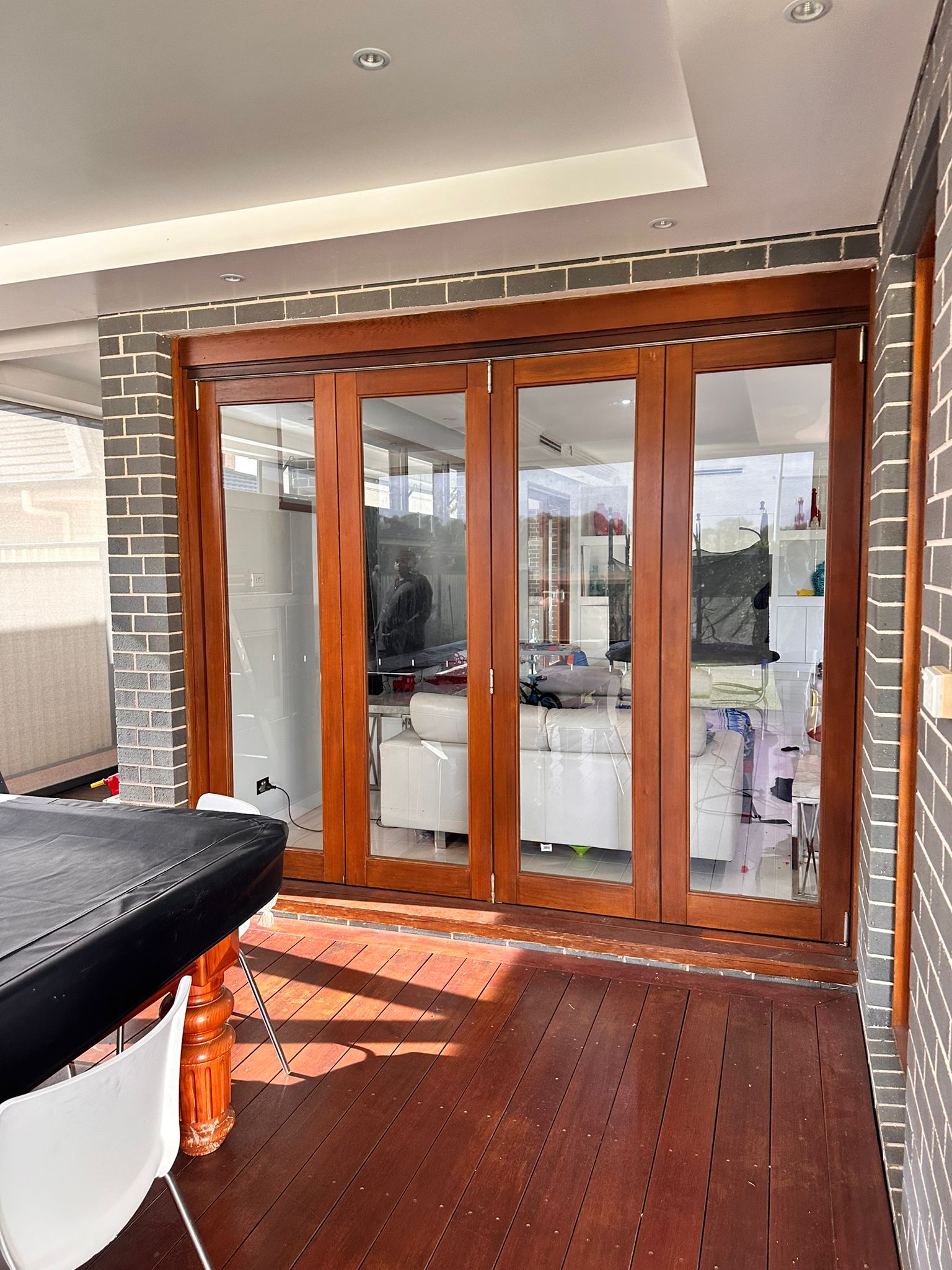 A room with a table and chairs and sliding glass doors