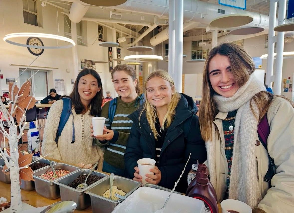 A large group of people are posing for a picture in a room.