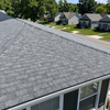 Gray shingle roof on a house in a suburban neighborhood on a sunny day
