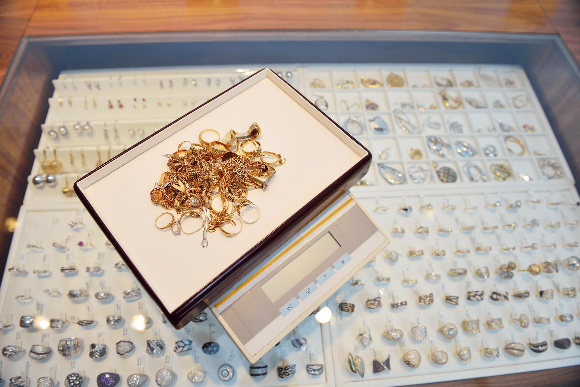 A pile of gold jewelry is sitting on top of a scale.