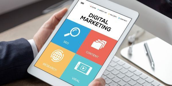 Person holding a tablet displaying a Digital Marketing menu with icons for SEO, Content, Research, and Viral services.