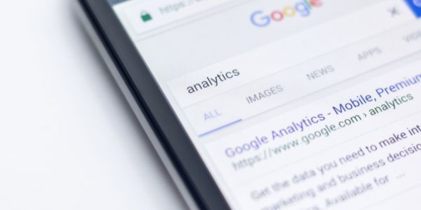 A close-up of a smartphone screen showing a Google search results page for the query 