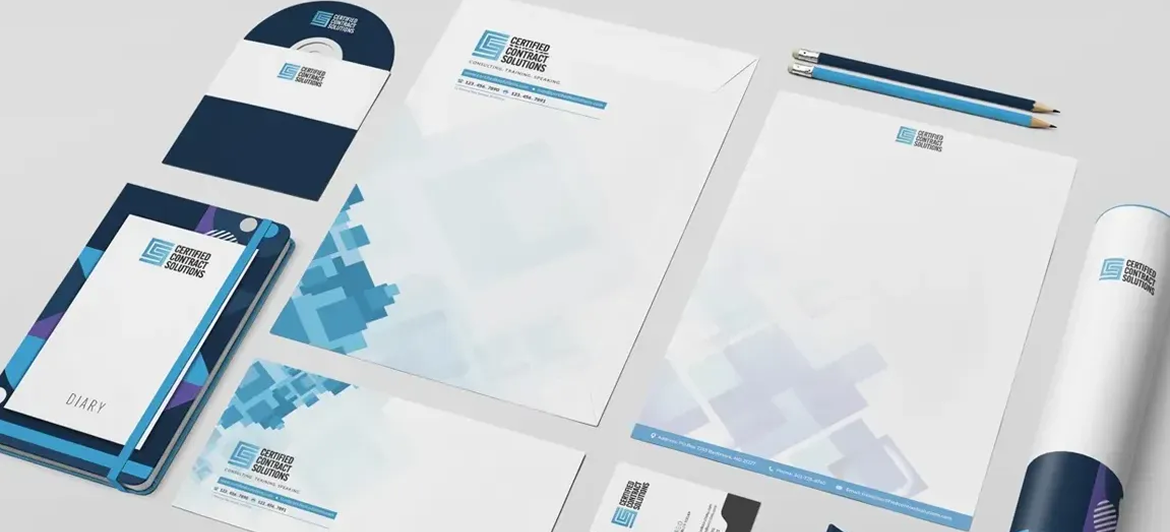 Corporate branding stationery set featuring business cards, letterheads, and notebooks in blue and white geometric patterns.