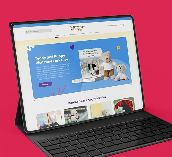 A tablet with a keyboard displaying the Teddy and Puppy & Co. website, featuring a teddy bear and puppy storybook.