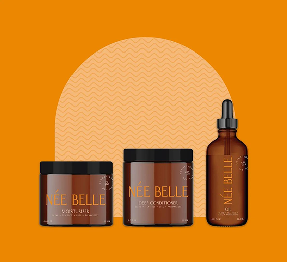 Three amber-colored Née Belle beauty product containers arranged against a golden-orange background with a wavy arch.