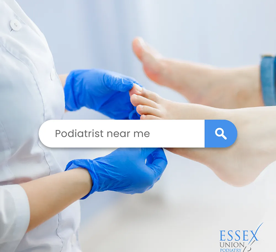 A healthcare professional in blue gloves examines a patient's feet, with a search bar reading 