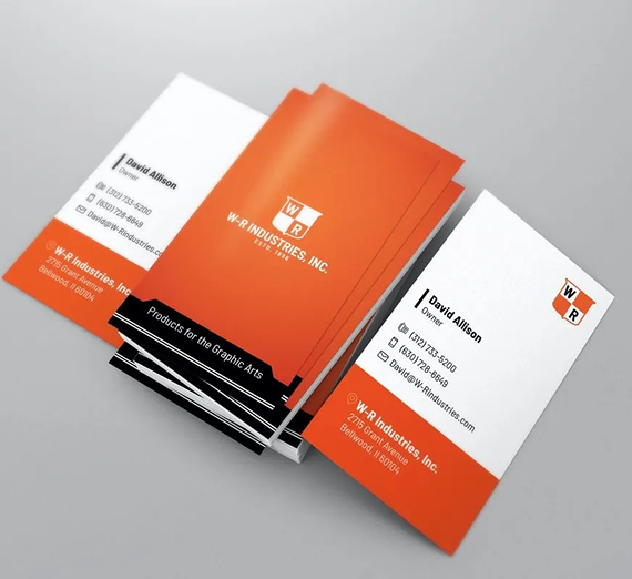 A stack of white and orange W-R Industries business cards featuring a logo, contact information, and address.