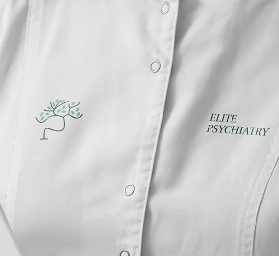 A white medical coat features a green, tree-shaped neural logo and the embroidered text 