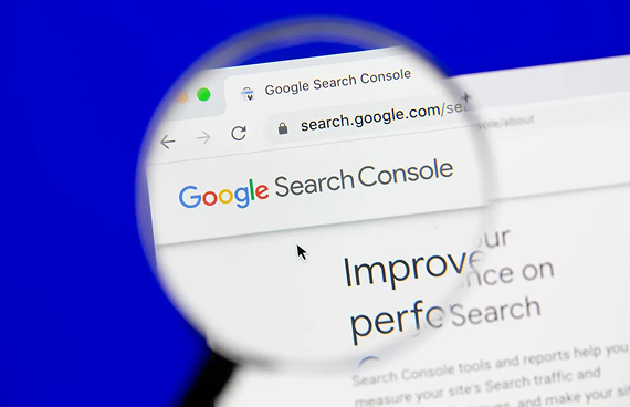 A magnifying glass focuses on the Google Search Console website on a computer screen against a blue background.