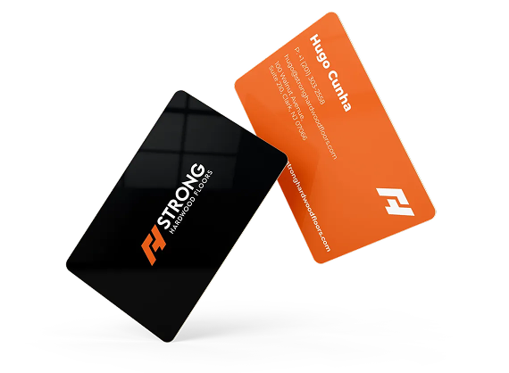 Two business cards, one black with an orange logo and one orange with white text, floating against a white background.