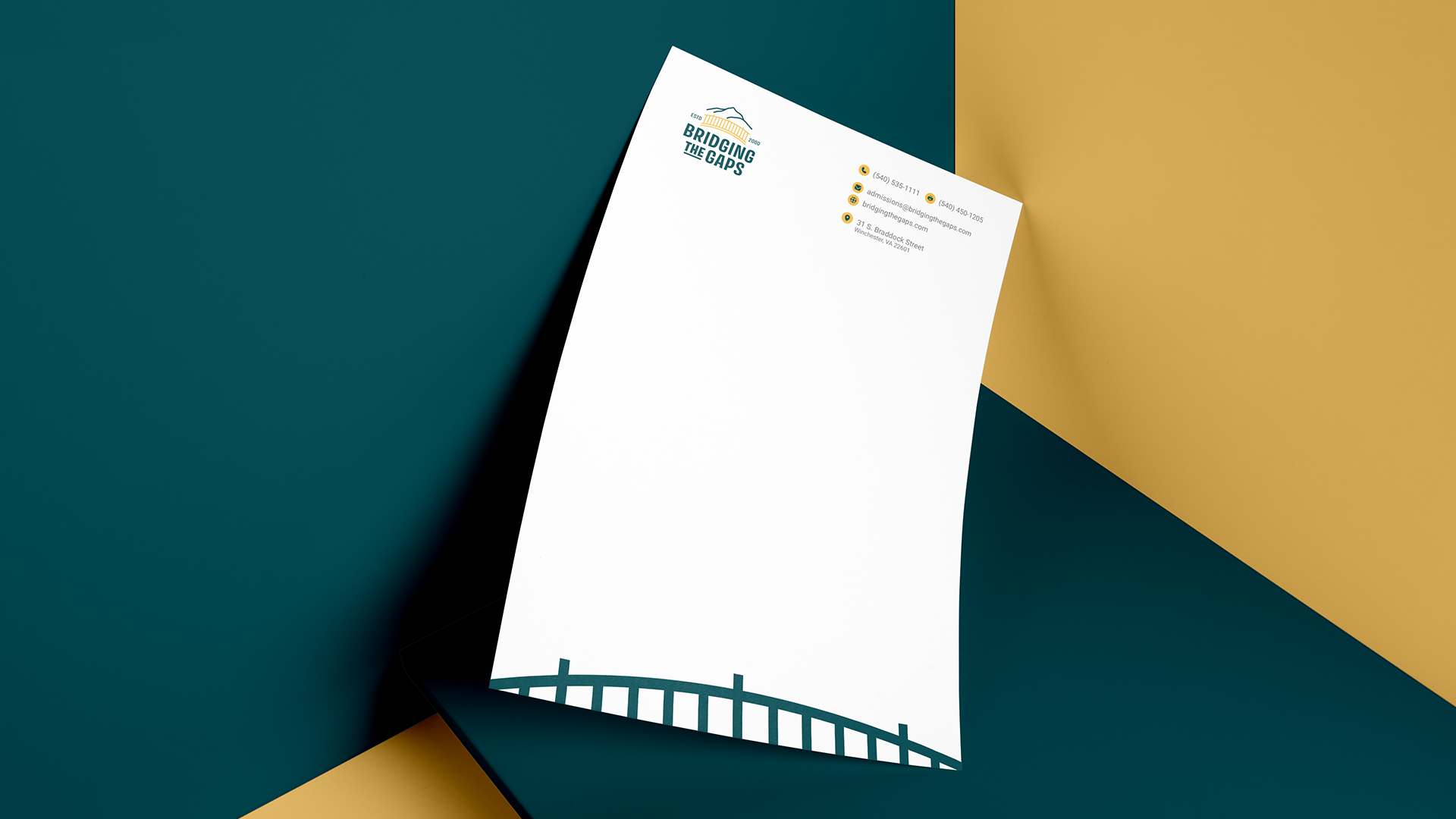 A letterhead template with a logo, contact info, and a bridge graphic at the bottom, displayed on a teal and gold background.