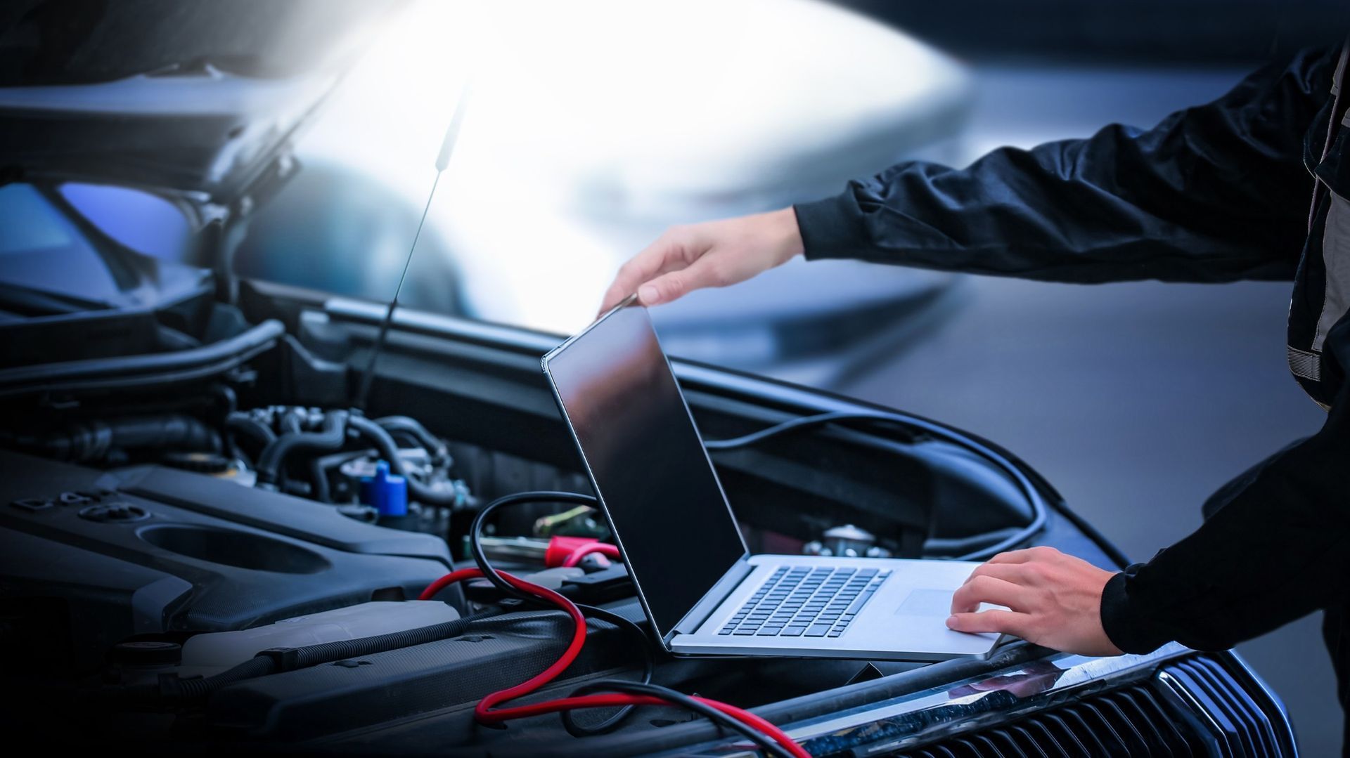 Laptop on car engine hood