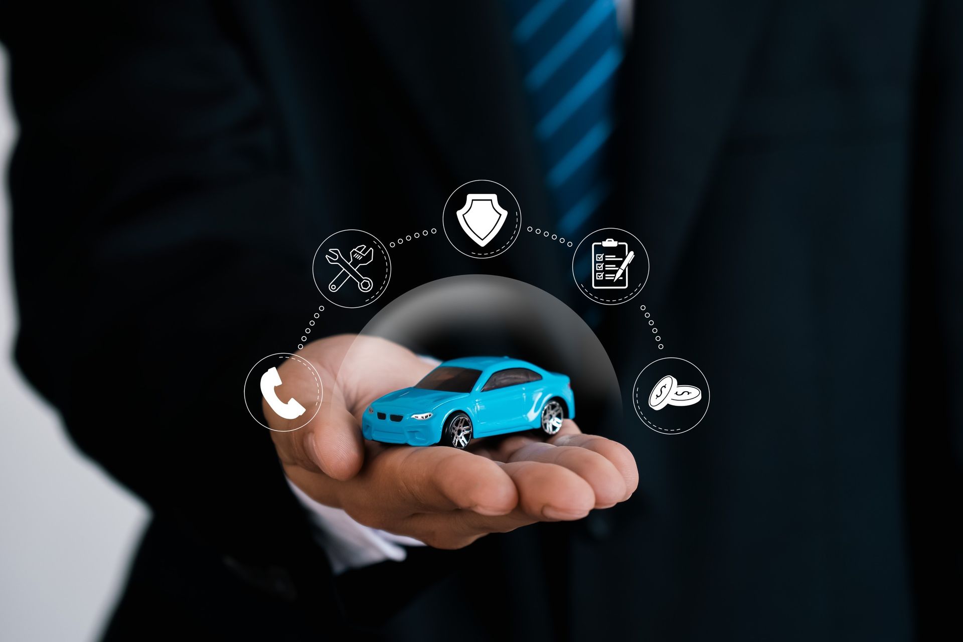Businessman holding toy car
