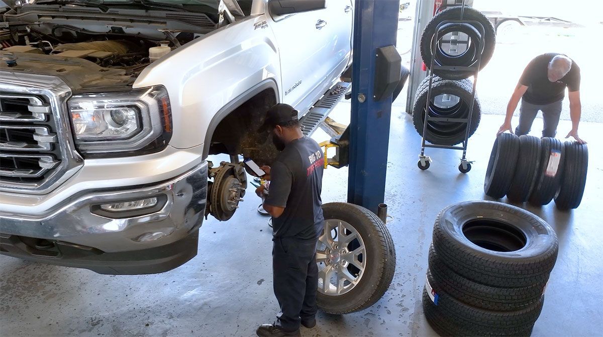 A close up of a brake disc and pads on a white background