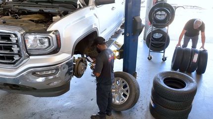 A close up of a brake disc and pads on a white background