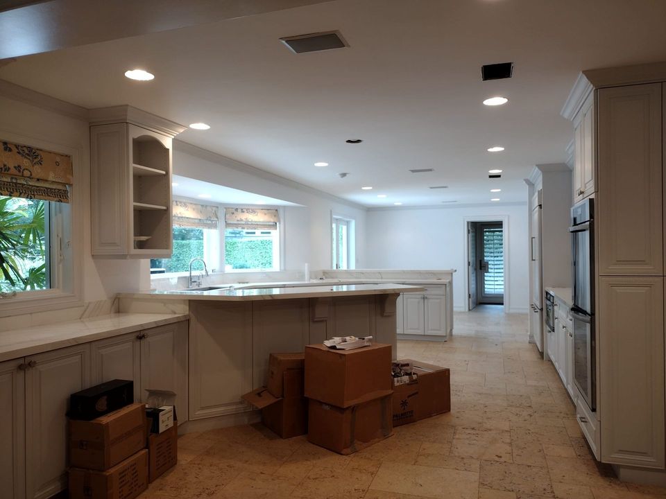 A ladder is sitting in front of a house under construction.