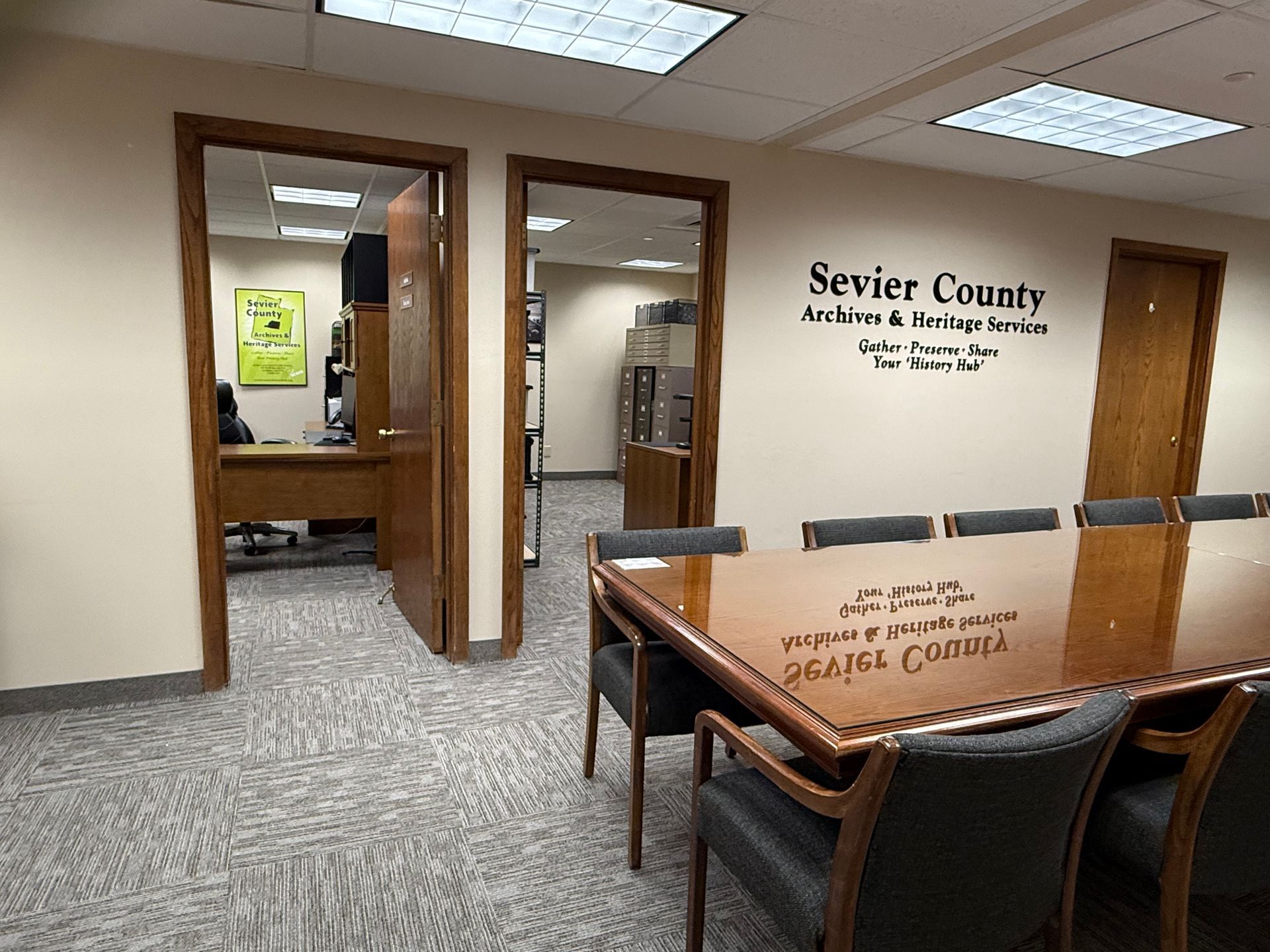 Interior office with conference table, doors, and