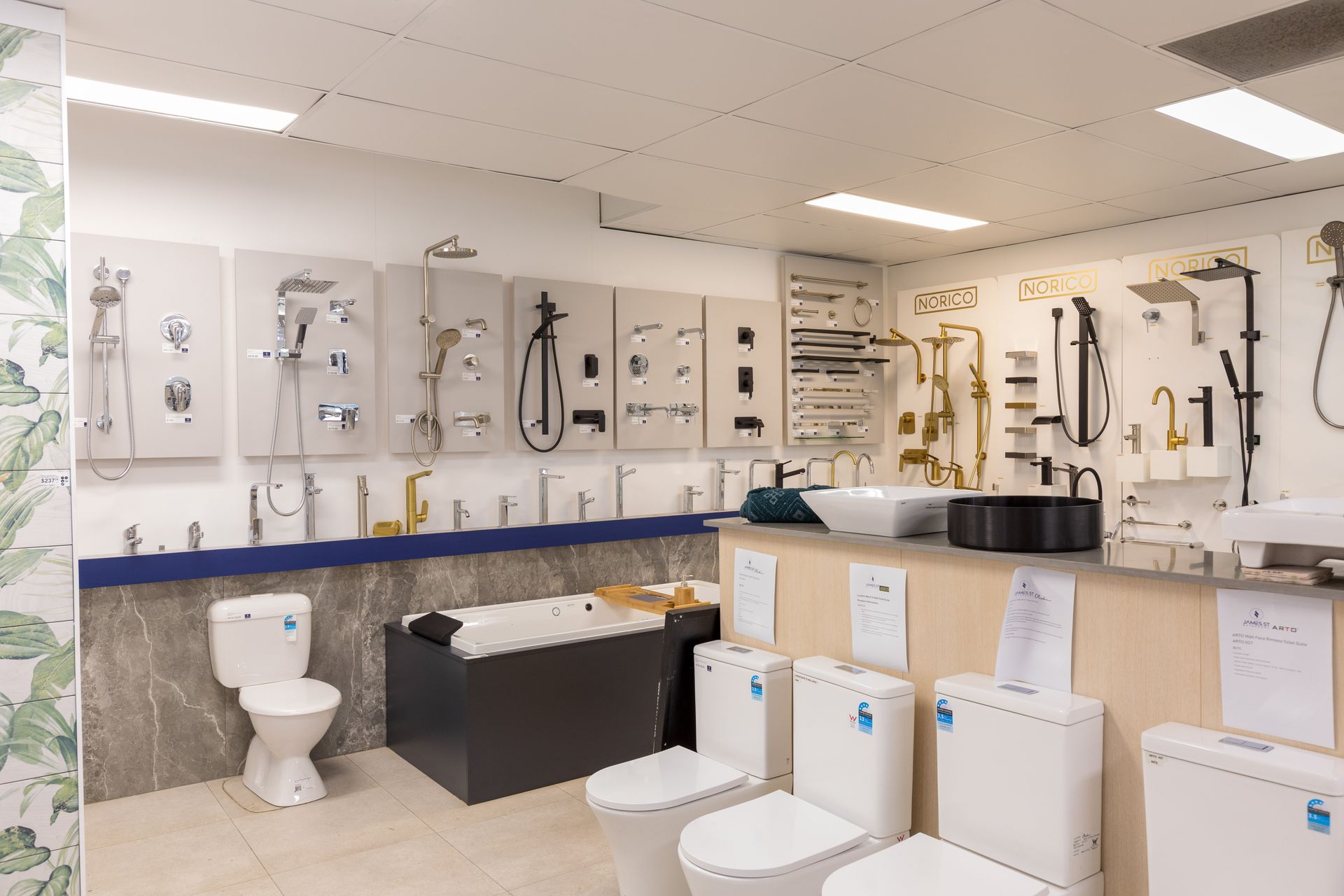 Bathroom fixture showroom with toilets and faucet displays.