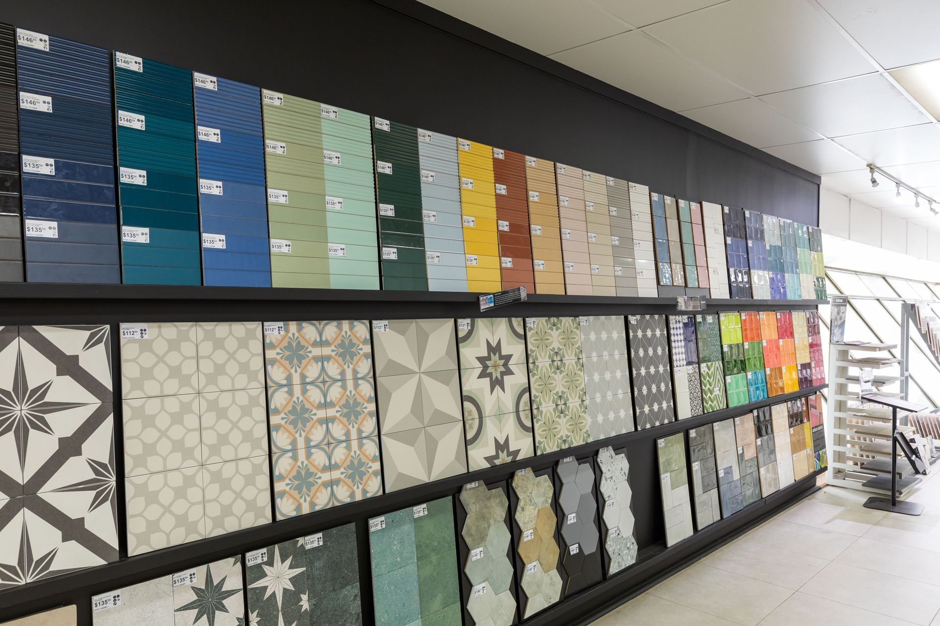 Tile display wall with various colours and patterns in a store.