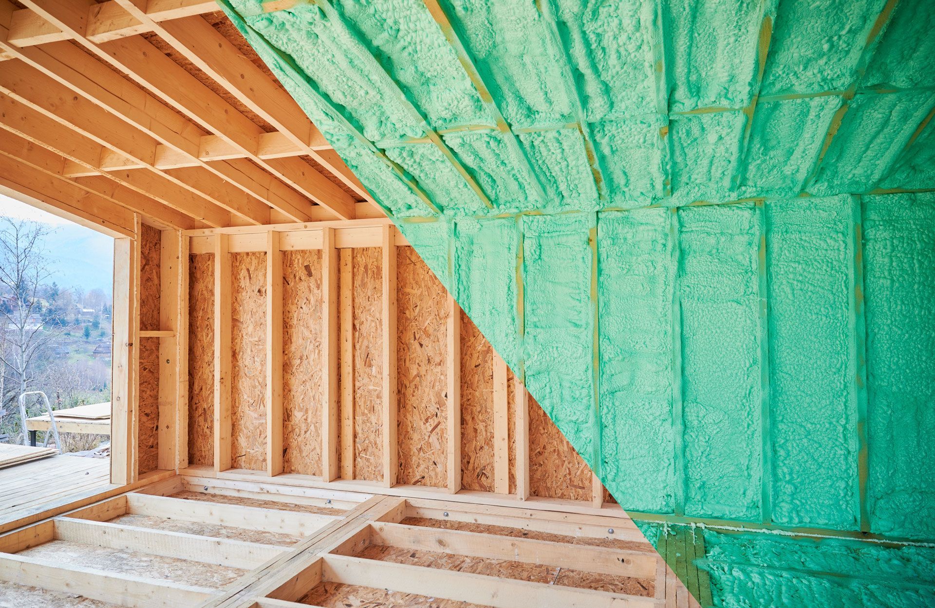 Interior view of a building under construction, showing wooden beams, insulation, and partially installed drywall.