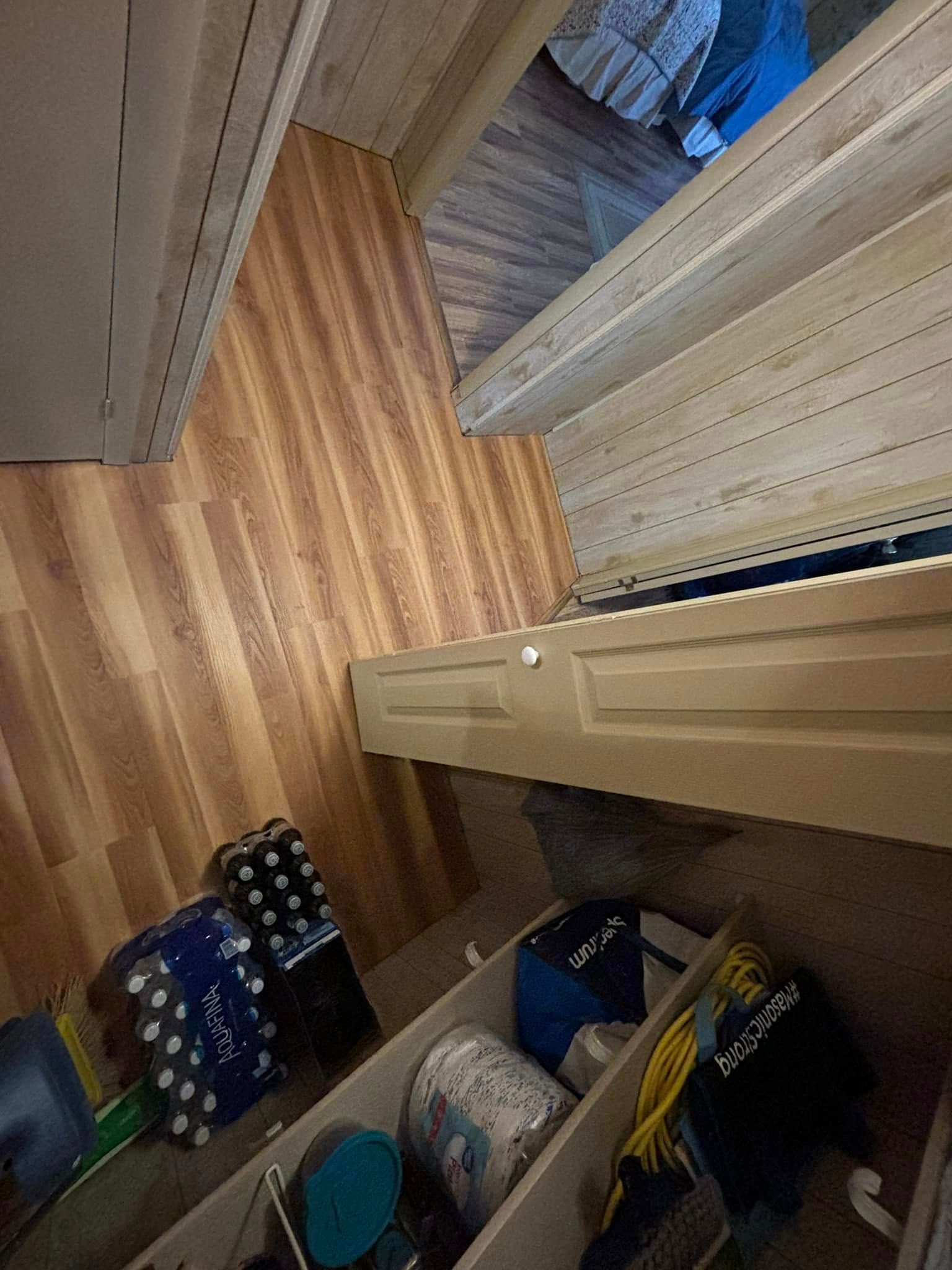 Wooden cabinet with storage, containing various items.