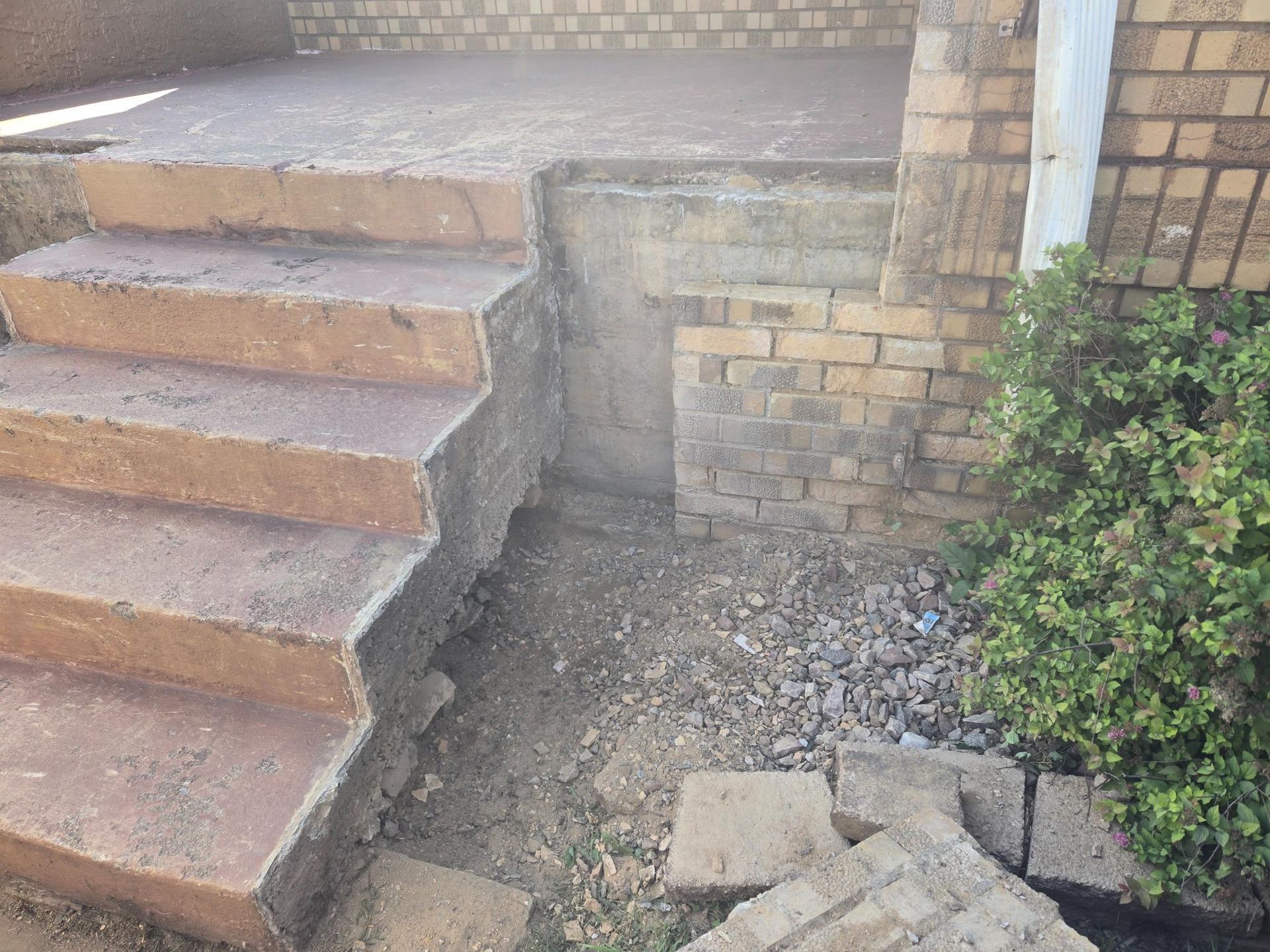 A set of stairs leading up to a brick building