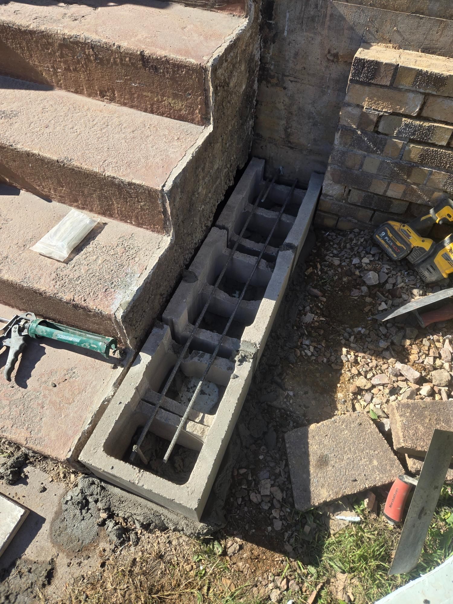 A concrete block is sitting next to a set of stairs.
