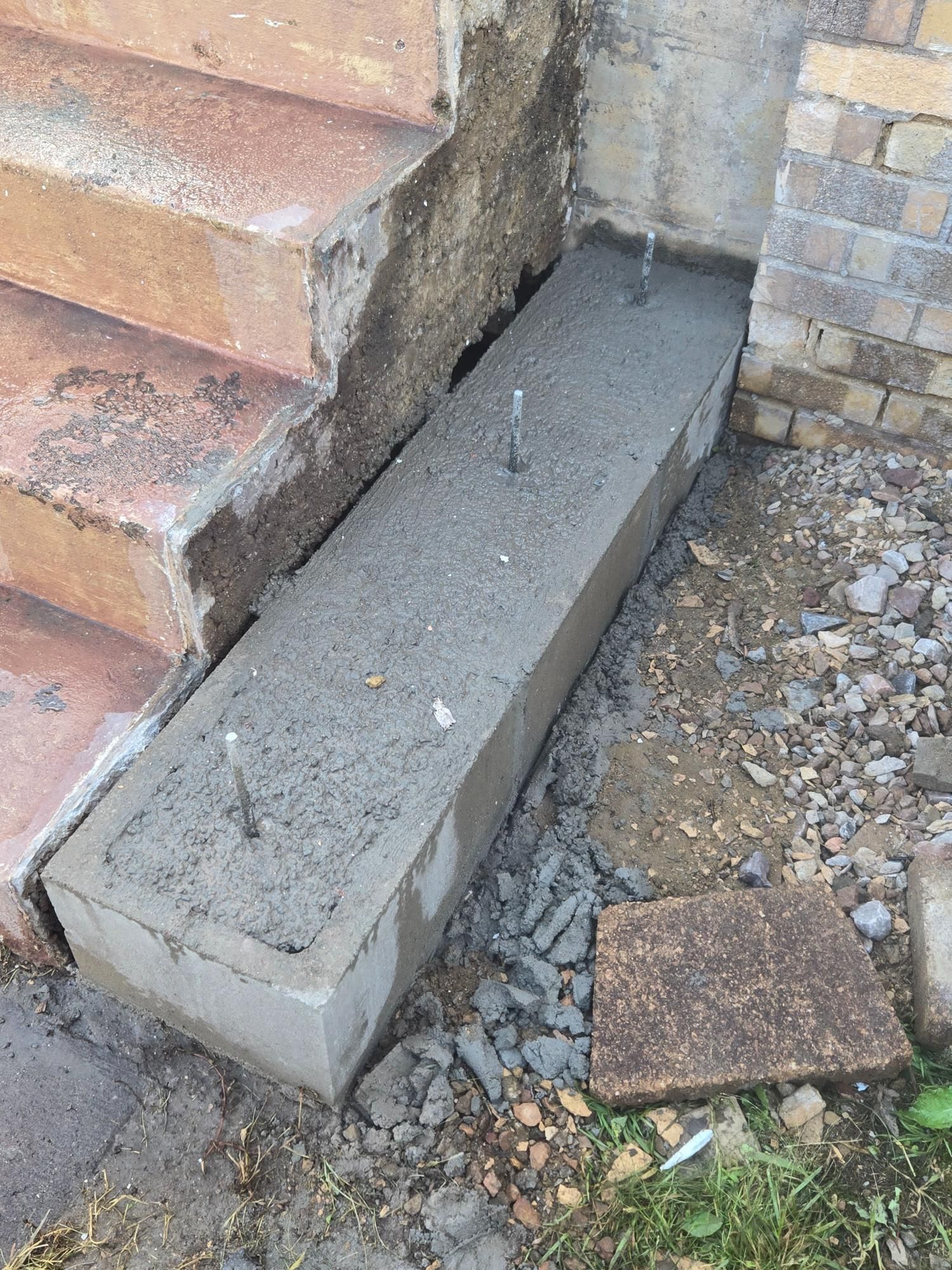 A concrete block is sitting next to a set of stairs.