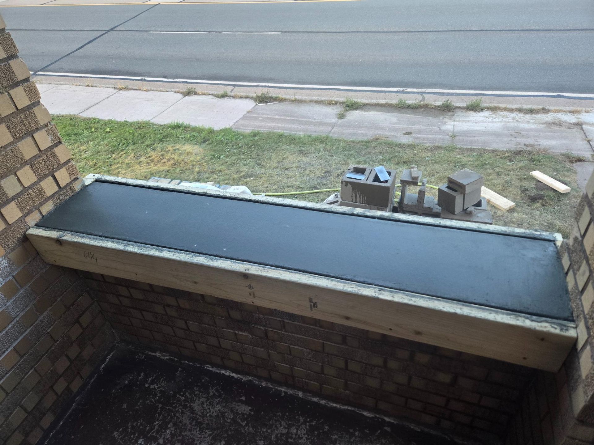 A brick building with a black bench in front of it