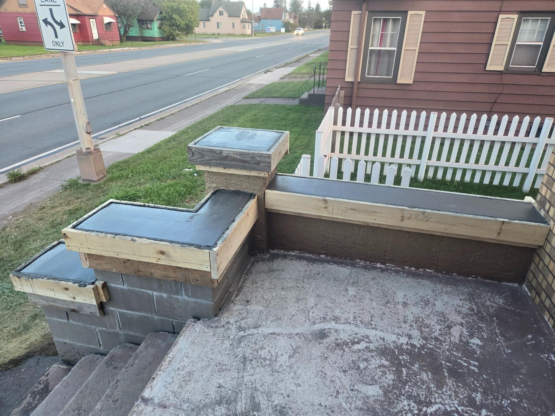 A house with a white picket fence and stairs leading up to it