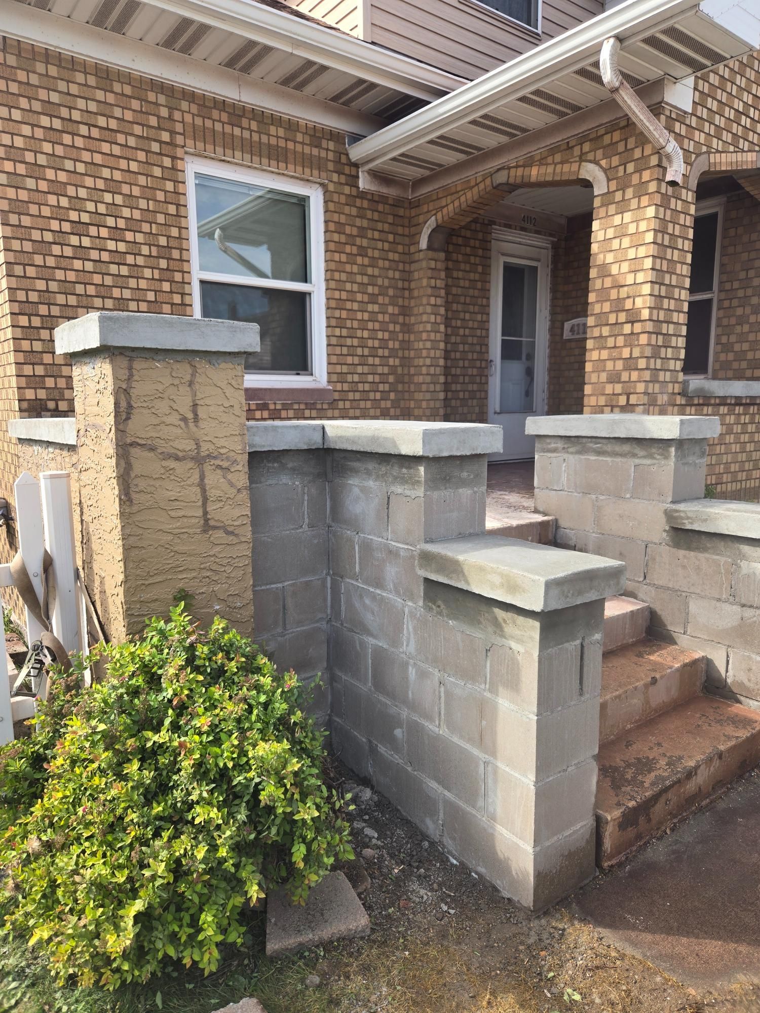 A brick house with a brick wall and stairs