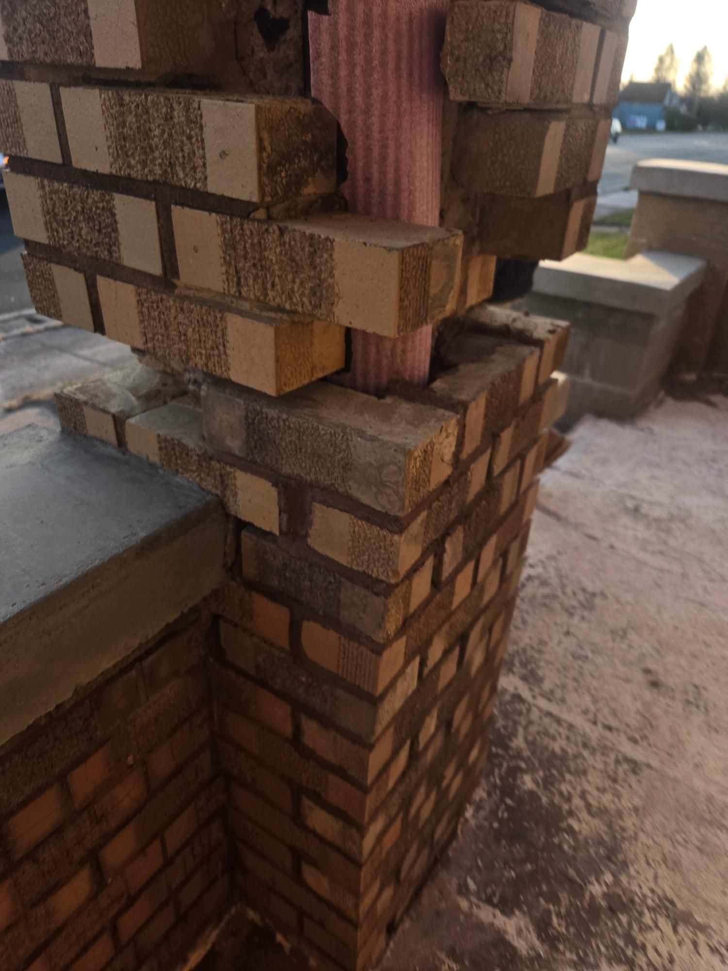 A close up of a brick wall with bricks stacked on top of each other